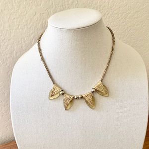 Preowned triangle pedant gold necklace.